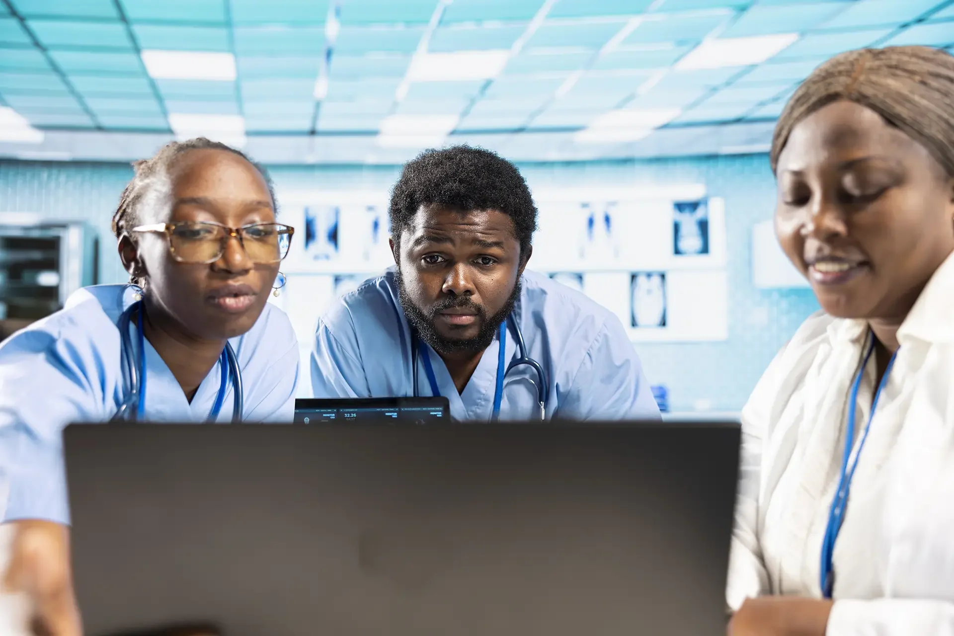 African healthcare professionals reviewing data on a laptop