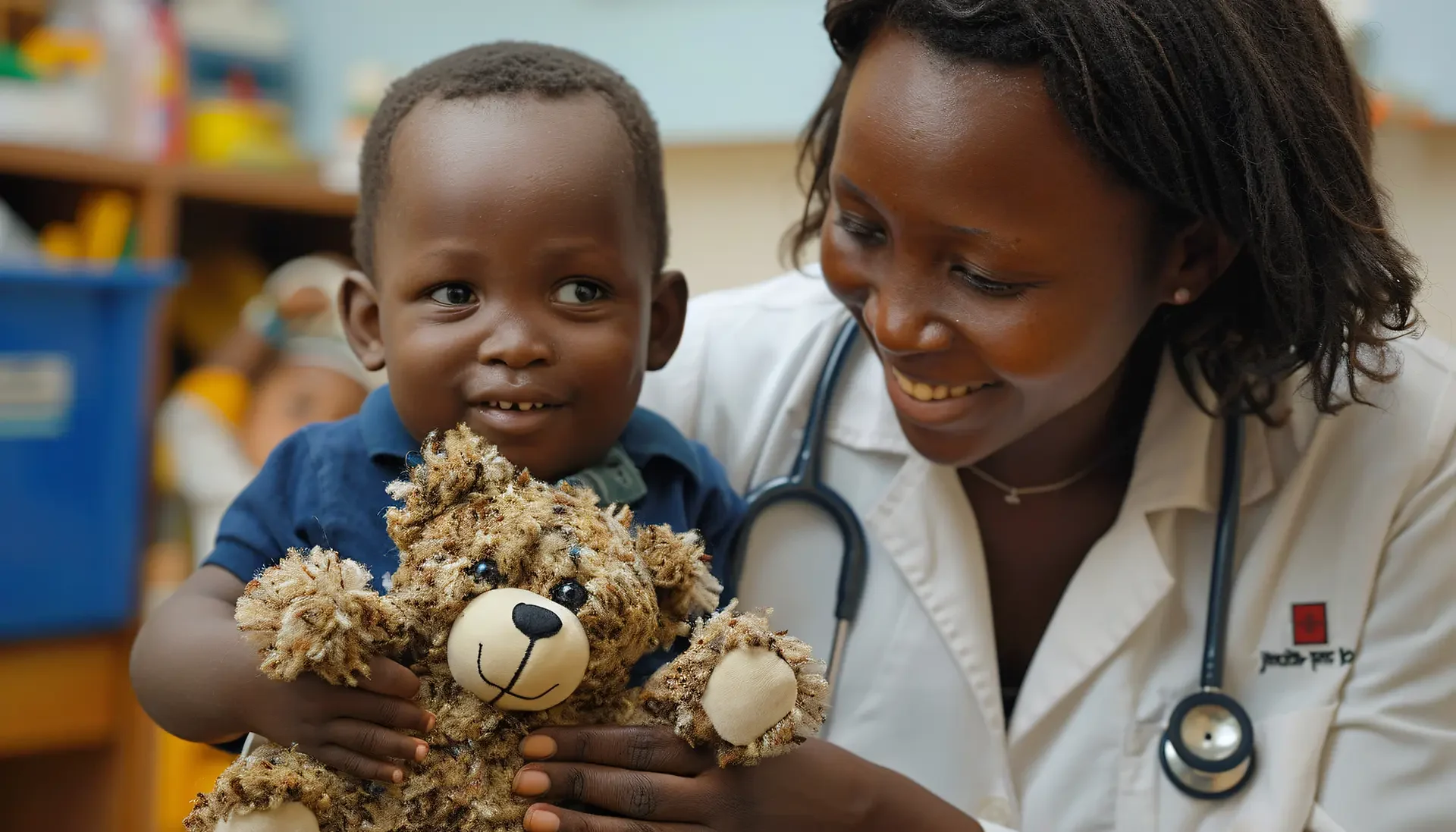 African child with a doctor holding a teddy bear