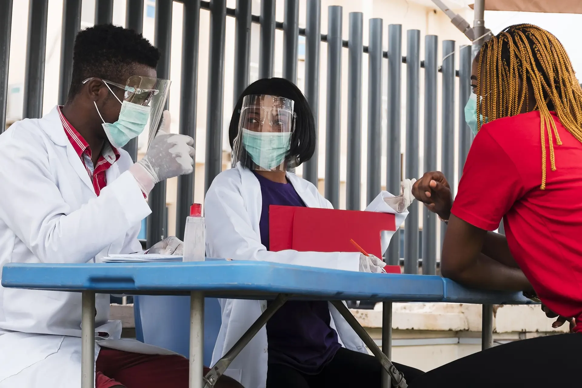 Health workers wearing PPE at field testing station