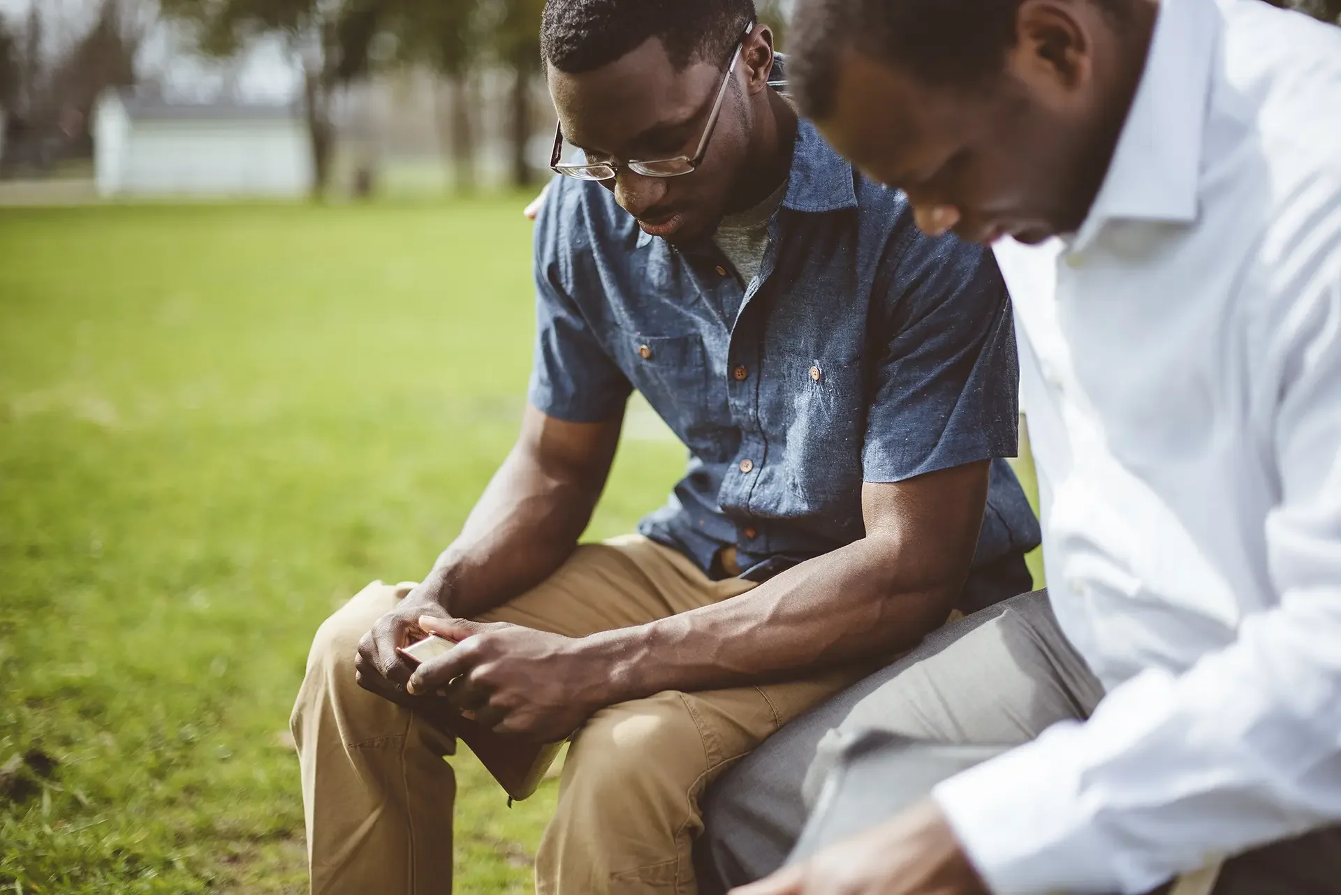 Two men sitting outdoors in conversation